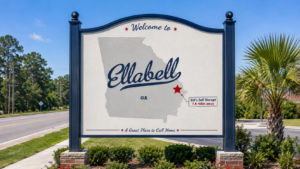 Ellabell - Sid's Self Storage - Sid's Self Storage Welcome to Ellabell, Georgia sign with a gray Georgia map and a red star marking Sid's Self Storage 7.8 miles away.